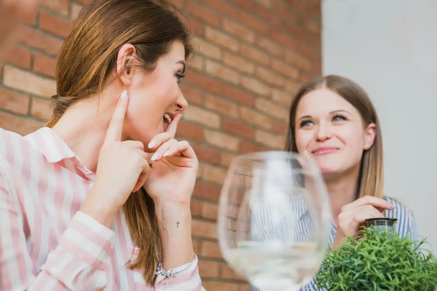 Falar sobre a vida dos outros pode afetar relações e aumentar o estresse. Duas pessoas conversando, uma delas sussurrando algo enquanto a outra reage de maneira curiosa.