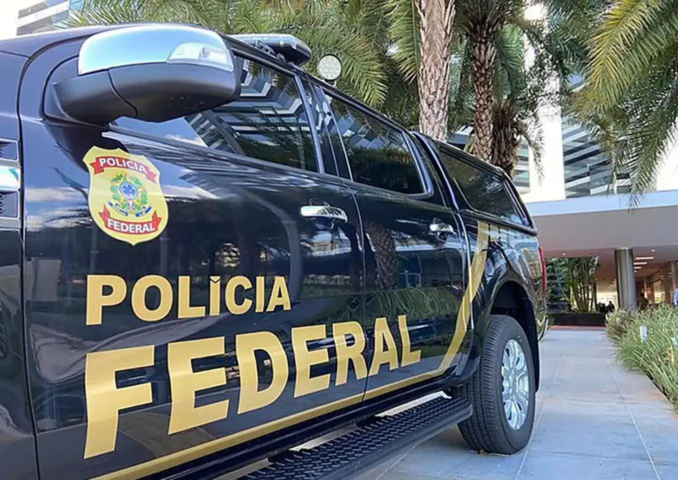 Veículo da Polícia Federal estacionado com detalhes visíveis da placa e logotipo.