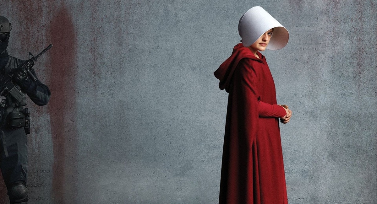Série "The Handmaid's Tale" para o Enem Cartaz de divulgação da série "The Handmaid's Tale", mostrando uma aia com a touca branca e um soldado.