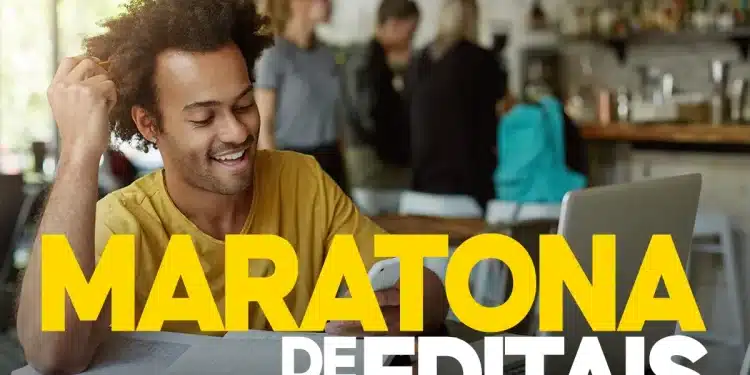 Candidato sorridente estudando em notebook durante maratona de editais de concursos públicos em ambiente de café