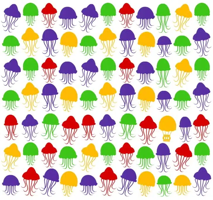 Procure o balão de ar quente escondido entre as várias imagens repetidas de águas-vivas coloridas. Desafio visual com padrão de ilustrações coloridas de águas-vivas em vermelho, verde, amarelo e roxo.