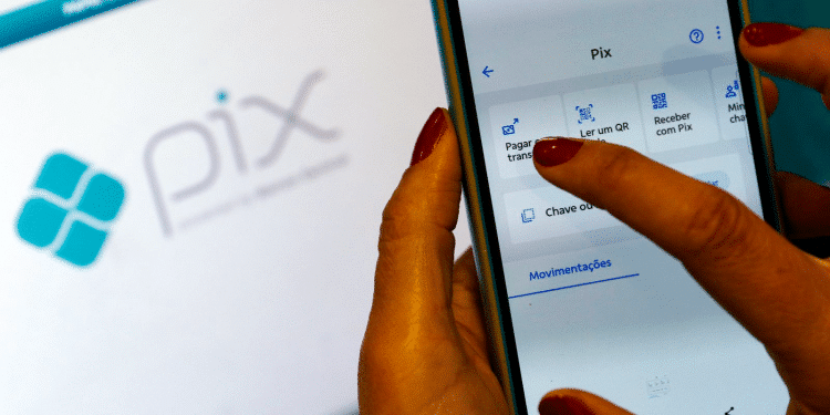 Pessoa utilizando o aplicativo Pix no celular, com interface para realizar pagamentos e transferências.