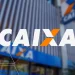 Fachada de agência bancária CAIXA Econômica Federal com logo em destaque e prédio moderno ao fundo