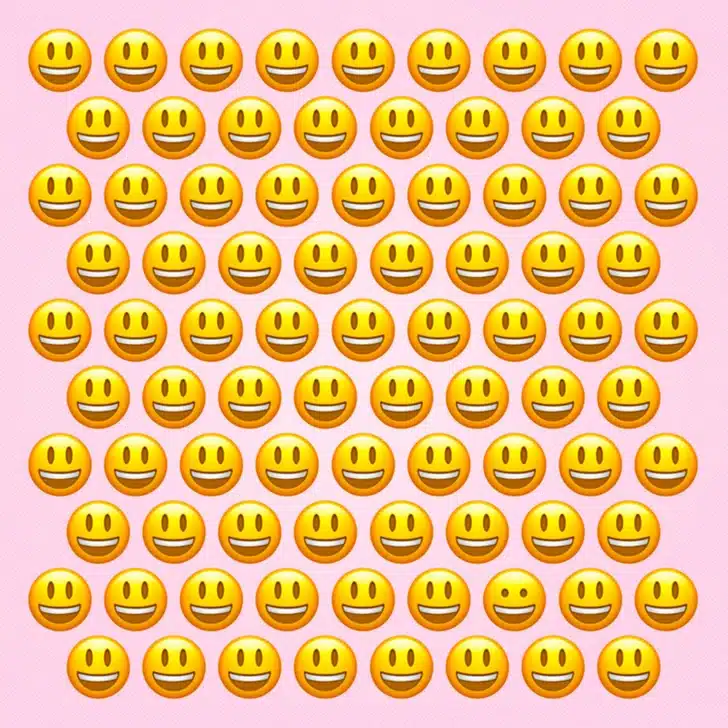 Ache o emoji fora do padrão na imagem com vários emojis sorrindo. Teste visual com vários emojis amarelos sorridentes alinhados em fundo rosa claro