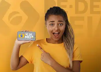 Jovem mulher com expressão surpresa segurando celular que mostra logo Pé de Meia e frase A poupança do ensino médio