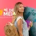 Estudante sorrindo com mochila e livros ao lado da campanha Pé-de-Meia sobre pagamento de R$ 1.000.
