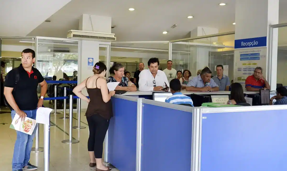 Segurados aguardam atendimento em agência do INSS em meio à fila de benefícios previdenciários