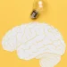 Ilustração do cérebro com lâmpada, simbolizando inteligência emocional.