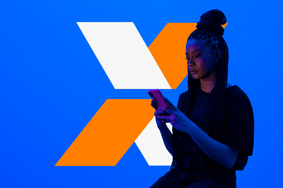 Mulher utilizando celular em frente ao logo da Caixa Econômica Federal para acessar aplicativo do FGTS
