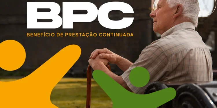 Idoso sentado em banco de praça apoia as mãos sobre bengala, olhando para o horizonte