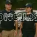 Dois agentes da Guarda Municipal fardados com colete e boné em frente a viatura com texto concurso sobreposto