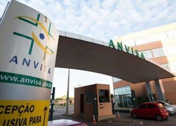 Fachada da sede da Anvisa em Brasília com totem de recepção e logotipo da agência