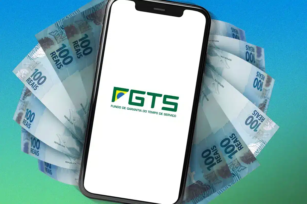 Imagem mostrando um smartphone com o logo do FGTS e notas de 100 reais ao fundo, ilustrando o saque-aniversário do FGTS em 2026.