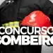 Bombeiro militar de costas com uniforme preto e faixas refletivas amarelas segurando capacete vermelho, com o texto Concurso Bombeiro em destaque, ilustrando o concurso público do Corpo de Bombeiros Militar de Minas Gerais 2026 para o cargo de Soldado Combatente.