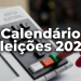 Mão feminina pressionando botão verde "Confirma" em urna eletrônica com inscrição Justiça Eleitoral