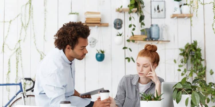 Colega oferece apoio a profissional em conversa que demonstra inteligência emocional no trabalho