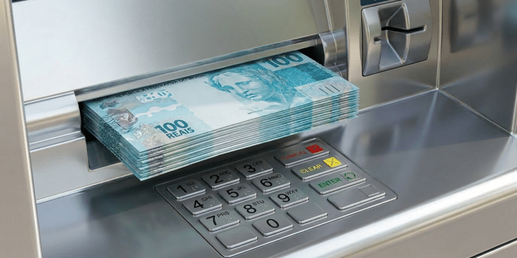Caixa eletrônico prateado libera maço de cédulas de cem reais durante saque do abono salarial