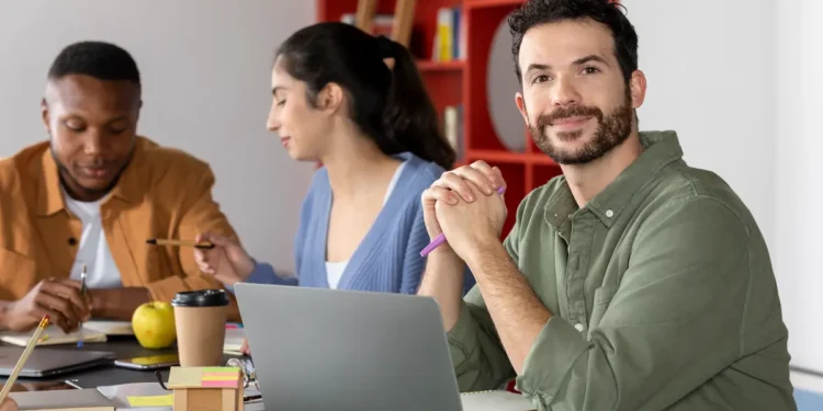 Coordenador pedagógico analisando materiais educacionais em ambiente escolar.