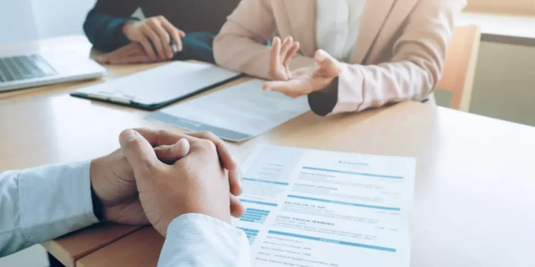 Candidato participa de entrevista de emprego e conversa sobre pretensão salarial com recrutadores.