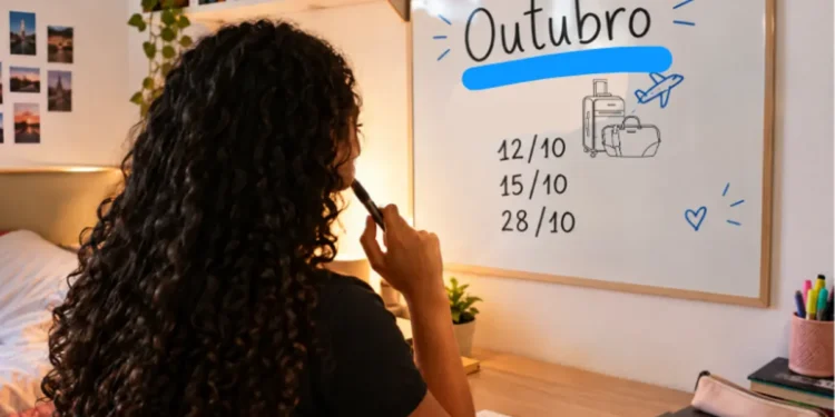 Jovem planejando viagens em outubro com quadro branco e datas destacadas.
