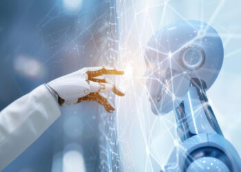 Imagem ilustrativa de mão robótica tocando a interface de uma rede digital luminosa, com a cabeça de um humanoide ao lado, representando o avanço da inteligência artificial no trabalho.