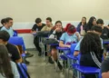 Estudantes interagem em sala de aula no ensino médio público brasileiro.