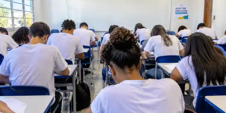 Alunos fazendo prova em sala de aula.
