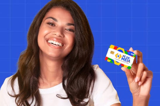 Imagem ilustrativa de jovem estudante sorridente segurando o cartão da parcela do Pé-de-Meia, em fundo azul quadriculado